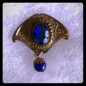 Old fashioned blue stone brooch